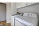 Bright laundry room featuring modern washer, dryer, and cabinetry at 50 Caroline Ave, Stockbridge, GA 30281