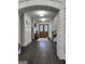 Grand foyer with brick archway, wood floors, and elegant lighting at 155 Green Meadow Ln, Fayetteville, GA 30215