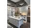 Spacious kitchen features a large island, wood beams, and custom cabinetry at 155 Green Meadow Ln, Fayetteville, GA 30215