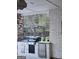 Outdoor kitchen boasts a grill, stainless steel refrigerator, granite counters and pergola-covered hot tub at 155 Green Meadow Ln, Fayetteville, GA 30215