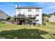 Large backyard with a spacious deck, patio, and lush green lawn, perfect for outdoor enjoyment at 3006 Gold Creek Dr, Villa Rica, GA 30180