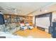 Cozy basement with built-in shelving, a large projector screen, comfortable seating, and wood-look flooring at 3006 Gold Creek Dr, Villa Rica, GA 30180