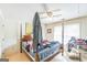 A bedroom with a four-poster bed covered in clothing and personal items at 3006 Gold Creek Dr, Villa Rica, GA 30180
