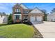 Charming two-story brick home featuring a well-manicured lawn, two-car garage, and lovely curb appeal at 3006 Gold Creek Dr, Villa Rica, GA 30180