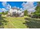 Exterior shot of a backyard with a large green lawn and a two-story home at 3006 Gold Creek Dr, Villa Rica, GA 30180