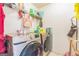 Laundry room with front-load washer and dryer set, shelving, and tile floors at 3006 Gold Creek Dr, Villa Rica, GA 30180