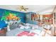Open living room with colorful accent wall, hardwood floors, and comfortable seating area at 3006 Gold Creek Dr, Villa Rica, GA 30180