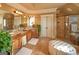 Bright bathroom has a double vanity, walk-in shower, and garden tub at 1345 Cashiers Way, Roswell, GA 30075