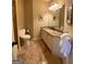 Bathroom features include a vanity with granite counters, tile flooring and bronze fixtures at 1345 Cashiers Way, Roswell, GA 30075