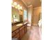 Bright bathroom boasting stone counters, wood cabinets, and a glass shower at 1345 Cashiers Way, Roswell, GA 30075