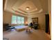 Bright bedroom features neutral walls and carpet, tray ceilings and a large window at 1345 Cashiers Way, Roswell, GA 30075