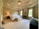 Bedroom featuring trey ceilings, soft natural light, and neutral carpet at 1345 Cashiers Way, Roswell, GA 30075