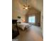 Comfortable bedroom with a ceiling fan, neutral decor, and a window with sheer curtains offering soft natural light at 1345 Cashiers Way, Roswell, GA 30075