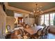 Elegant dining room featuring wainscoting, a chandelier, and views into the library at 1345 Cashiers Way, Roswell, GA 30075