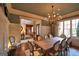 A formal dining room showcasing a large wooden table, decorative chandelier, and paneled walls at 1345 Cashiers Way, Roswell, GA 30075