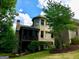 Back exterior showcasing a brick home, manicured lawn, and screened in porch at 1345 Cashiers Way, Roswell, GA 30075