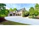 Stunning brick home with a three-car garage, long driveway, and mature landscaping at 1345 Cashiers Way, Roswell, GA 30075