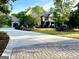 Beautiful two-story brick home with attached garage, large driveway, and manicured landscaping at 1345 Cashiers Way, Roswell, GA 30075