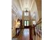 Stunning foyer with tall ceilings, an elegant chandelier, and gleaming hardwood floors at 1345 Cashiers Way, Roswell, GA 30075