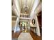 Grand foyer with hardwood floors, soaring ceilings, elegant chandelier, and staircase at 1345 Cashiers Way, Roswell, GA 30075