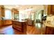 Open concept kitchen with wood cabinets, double islands, and stainless steel appliances at 1345 Cashiers Way, Roswell, GA 30075