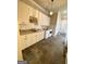 Bright laundry room features a front loading washer and dryer with granite countertops and tile floors at 1345 Cashiers Way, Roswell, GA 30075
