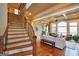 Elegant living room with large windows, fireplace, and hardwood floors; open concept design at 1345 Cashiers Way, Roswell, GA 30075
