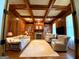 Wood paneled living room with fireplace, coffered ceiling, and built-in bookshelves at 1345 Cashiers Way, Roswell, GA 30075