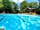 Inviting community pool surrounded by lush greenery and lounge chairs at 1345 Cashiers Way, Roswell, GA 30075
