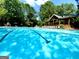 Community pool with chairs and a covered area next to the water at 1345 Cashiers Way, Roswell, GA 30075
