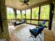 Screened porch with swing, ceiling fan, and outdoor seating at 1345 Cashiers Way, Roswell, GA 30075