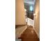 Elegant wooden staircase with white trim and a decorative wrought iron railing leads to a bright upper level with an oval window at 1345 Cashiers Way, Roswell, GA 30075