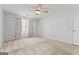 Large bedroom with neutral carpet, large window with curtains and a ceiling fan at 135 Gingercake Ct, Fayetteville, GA 30214