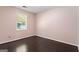 Simple bedroom with hardwood-look floors, one window, and neutral paint at 135 Gingercake Ct, Fayetteville, GA 30214