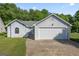 Charming single-story home featuring a two-car garage and well-maintained lawn at 135 Gingercake Ct, Fayetteville, GA 30214