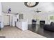 Open-concept kitchen and living room showcasing a breakfast bar and fireplace, ideal for entertaining at 135 Gingercake Ct, Fayetteville, GA 30214