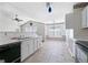 Bright kitchen with white cabinets, tile floors, and open layout at 135 Gingercake Ct, Fayetteville, GA 30214