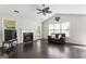 Bright living room with vaulted ceilings, fireplace, and dark hardwood floors at 135 Gingercake Ct, Fayetteville, GA 30214