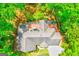 Aerial view of house showing roof, driveway, deck, and surrounding greenery at 8575 Haven Wood Trl, Roswell, GA 30076