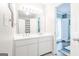 Bright bathroom featuring a double vanity with white cabinets and modern fixtures at 8575 Haven Wood Trl, Roswell, GA 30076