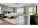 Serene bedroom with a king-size bed, soft lighting, and access to a private balcony at 8575 Haven Wood Trl, Roswell, GA 30076