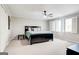 Spacious bedroom with carpet, ceiling fan, natural lighting, and neutral decor at 8575 Haven Wood Trl, Roswell, GA 30076