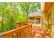 Expansive deck with screened-in porch, offering panoramic views of the surrounding forest at 8575 Haven Wood Trl, Roswell, GA 30076