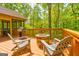 Outdoor deck with a grill and fire pit, perfect for enjoying the surrounding nature at 8575 Haven Wood Trl, Roswell, GA 30076