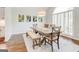 Inviting dining room with a large wooden table, a bench and beautiful artwork at 8575 Haven Wood Trl, Roswell, GA 30076