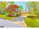 Charming home with lush landscaping, colorful flowers, and a welcoming stone-accented facade at 8575 Haven Wood Trl, Roswell, GA 30076