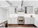 Modern kitchen featuring white cabinetry, stainless steel appliances, and a stylish backsplash at 8575 Haven Wood Trl, Roswell, GA 30076