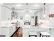 Modern kitchen with white cabinets, marble countertops, stainless steel appliances, and stylish lighting at 8575 Haven Wood Trl, Roswell, GA 30076