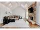 Spacious living room with vaulted ceiling, stone fireplace, hardwood floors, and ample seating at 8575 Haven Wood Trl, Roswell, GA 30076