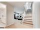 Spacious living area featuring a staircase, and a glimpse of the open floor plan at 8575 Haven Wood Trl, Roswell, GA 30076